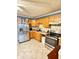 Functional kitchen featuring stainless steel appliances, light wood cabinets, and tiled floors at 4108 Patricia St, Indianapolis, IN 46222