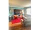 Cozy living room featuring a large TV, plush seating, and a vibrant red rug at 4108 Patricia St, Indianapolis, IN 46222