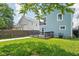 Backyard with a blue house, a small deck, and a walkway with grass at 422 Sanders St, Indianapolis, IN 46225