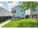 Backyard with a blue house, a small deck, and a walkway with grass at 422 Sanders St, Indianapolis, IN 46225