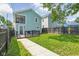 Backyard with a blue house, a small deck, and a walkway with grass at 422 Sanders St, Indianapolis, IN 46225