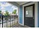 Balcony shows neighborhood views, blue siding and black door at 422 Sanders St, Indianapolis, IN 46225