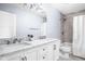 Bathroom with marble countertops, double sinks, and a shower tub with gray tiling at 422 Sanders St, Indianapolis, IN 46225