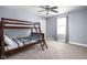 Bedroom with bunk beds, a window, neutral carpet, light blue walls, and a ceiling fan at 422 Sanders St, Indianapolis, IN 46225