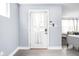 Bright entryway featuring a white front door, neutral walls, and hardwood floors leading into the living area at 422 Sanders St, Indianapolis, IN 46225