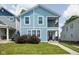 Charming two-story home with light blue siding, a small porch, and a well-maintained front yard at 422 Sanders St, Indianapolis, IN 46225