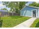 Exterior of detached garage with light blue siding and a personnel door. Green grass is in the foreground at 422 Sanders St, Indianapolis, IN 46225