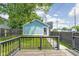 View of the detached garage with painted siding, a single personnel door, and black wooden fence at 422 Sanders St, Indianapolis, IN 46225