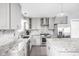 Modern kitchen with stainless steel appliances, gray cabinets, mosaic backsplash, and stone countertops at 422 Sanders St, Indianapolis, IN 46225