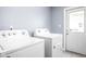 Laundry room featuring white washer and dryer units with a door to the outside at 422 Sanders St, Indianapolis, IN 46225