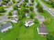 Aerial view of a home with a large backyard, mature trees, and a neighborhood setting close to a main road at 4442 Victory Cir, Indianapolis, IN 46203