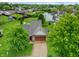 Aerial shot of a well-maintained home with a two-car garage, surrounded by mature trees and lush greenery at 4442 Victory Cir, Indianapolis, IN 46203