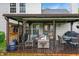 Cozy covered patio with comfortable seating, outdoor dining, and a mounted TV, perfect for relaxation and entertaining at 4442 Victory Cir, Indianapolis, IN 46203