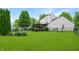 Expansive backyard with lush green lawn, vibrant flower beds, and patio, perfect for outdoor activities and relaxation at 4442 Victory Cir, Indianapolis, IN 46203