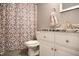 Stylish bathroom features a modern vanity with granite countertops and decorative shower curtain at 4442 Victory Cir, Indianapolis, IN 46203