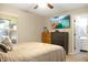 Comfortable bedroom featuring a ceiling fan, dresser, and an ensuite bathroom at 4442 Victory Cir, Indianapolis, IN 46203
