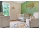 Charming Bedroom with a white crib, patterned rug, and green accent wall creating a cozy atmosphere at 4442 Victory Cir, Indianapolis, IN 46203