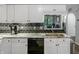Well-lit kitchen featuring sleek white cabinets, dark backsplash, granite countertops, and stainless steel appliances at 4442 Victory Cir, Indianapolis, IN 46203