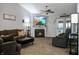 Spacious living room features a fireplace, ceiling fan, backyard access, and comfortable seating at 4442 Victory Cir, Indianapolis, IN 46203