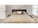 Well-lit main bedroom offers a queen-sized bed, side tables, and natural light at 4442 Victory Cir, Indianapolis, IN 46203