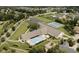 Aerial view of a community center with a pool, tennis courts, and playground, surrounded by homes and green spaces at 4763 Woods Edge Dr, Zionsville, IN 46077