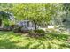 Beautifully landscaped backyard with lush greenery, mature trees, and well-maintained lawn at 4763 Woods Edge Dr, Zionsville, IN 46077