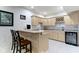 Well-lit basement kitchen area featuring counter seating, ample cabinets and wine rack at 4763 Woods Edge Dr, Zionsville, IN 46077