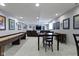 Finished basement with a shuffleboard table, kitchenet, seating, and recessed lighting at 4763 Woods Edge Dr, Zionsville, IN 46077