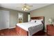 Bedroom featuring hardwood floors, a large bed, and a view into an adjoining bathroom at 4763 Woods Edge Dr, Zionsville, IN 46077