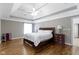 Spacious bedroom boasts hardwood floors, tray ceiling, and ample natural light at 4763 Woods Edge Dr, Zionsville, IN 46077