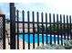 Community pool area featuring crystal clear water, a black metal safety fence and lounge chairs at 4763 Woods Edge Dr, Zionsville, IN 46077