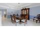 Formal dining room with a large wooden table, elegant chairs, and a glass display cabinet at 4763 Woods Edge Dr, Zionsville, IN 46077