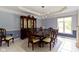Sophisticated dining room with a dark wood table, comfortable seating, and a stylish chandelier at 4763 Woods Edge Dr, Zionsville, IN 46077