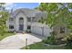 Stunning two-story white brick home with a three-car garage and a well-manicured front yard at 4763 Woods Edge Dr, Zionsville, IN 46077
