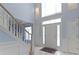 Bright foyer with a staircase, high ceilings, decorative windows, and neutral tile flooring at 4763 Woods Edge Dr, Zionsville, IN 46077