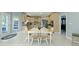 Eat-in kitchen features white table and chairs with tile flooring and a door to outside at 4763 Woods Edge Dr, Zionsville, IN 46077