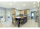 Open concept kitchen features a blue island with seating and light wood cabinetry at 4763 Woods Edge Dr, Zionsville, IN 46077