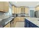 Kitchen features stainless steel appliances, granite countertops, and a blue island with seating at 4763 Woods Edge Dr, Zionsville, IN 46077