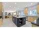 Open concept kitchen with central island and stainless appliances with view to living spaces at 4763 Woods Edge Dr, Zionsville, IN 46077