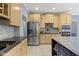 Kitchen features stainless appliances, granite countertops, and a view to living spaces at 4763 Woods Edge Dr, Zionsville, IN 46077