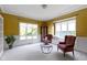 Sunlit living room featuring carpeted floors, elegant furniture, and large windows overlooking the yard at 4763 Woods Edge Dr, Zionsville, IN 46077