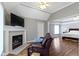 Inviting living room with fireplace opens to the adjacent bedroom for a seamless flow at 4763 Woods Edge Dr, Zionsville, IN 46077