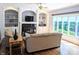 Inviting living room features a fireplace, built-in shelving, hardwood floors, and large windows at 4763 Woods Edge Dr, Zionsville, IN 46077
