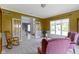 Cozy living room with a rocking chair, two armchairs, and French doors leading to the foyer at 4763 Woods Edge Dr, Zionsville, IN 46077
