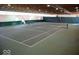 Indoor tennis court featuring professional net and lines, plus ample lighting for year-round enjoyment at 4763 Woods Edge Dr, Zionsville, IN 46077