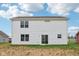 Backyard view of a white siding home with several windows and a glass sliding door at 5002 Amber Wood Dr, Lawrence, IN 46235