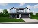 Charming two-story home with a well-manicured lawn, attached garage, and traditional architectural details at 5002 Amber Wood Dr, Lawrence, IN 46235