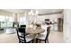 Bright kitchen with white cabinetry, stainless steel appliances, eat in kitchen and modern light fixtures at 5002 Amber Wood Dr, Lawrence, IN 46235