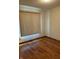 Bright bedroom offers wood floors, neutral walls, and blinds to provide pleasant light at 5148 Constitution Ct, Columbus, IN 47203