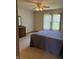 Spacious bedroom features neutral carpet, a ceiling fan, and a large window with blinds at 5148 Constitution Ct, Columbus, IN 47203